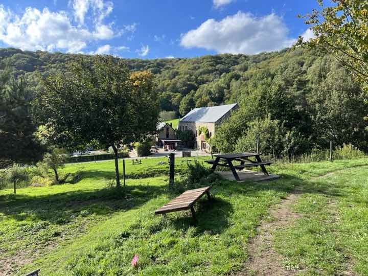 A farmhouse venue under a hill